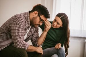 Woman consoling her partner under financial stress, seeking mortgage advice in Ontario - Mortgage Scout