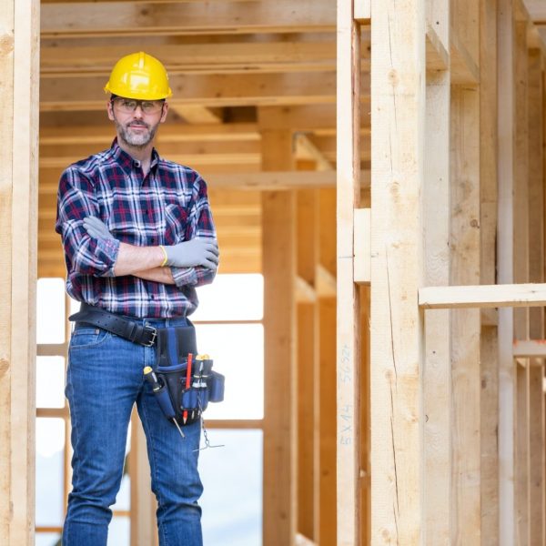 Builder worker on construction site of frame house in Ontario - Home Financing by Mortgage Scout