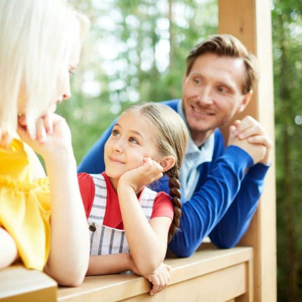Family with young child enjoying their new front porch in rural Ontario, considering first-time homebuyer mortgage options - Mortgage Scout