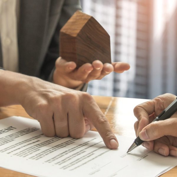 Mortgage brokerage representatives and home buyers signing a mortgage contract in Toronto, Ontario, Canada - Mortgage Scout