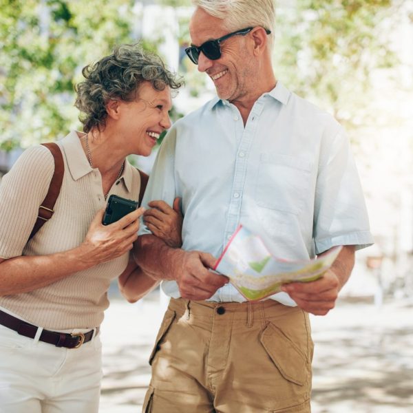 Retired couple enjoying financial freedom while walking around town, considering retirement mortgage options in Ontario - Mortgage Scout